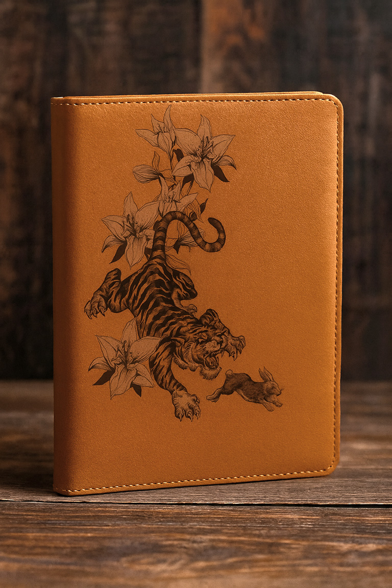 Illustration of a tiger chasing a rabbit, screen printed on a leather bound notebook